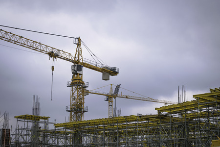 Industrial construction site crane on a cloudy day