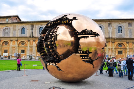 Golden Ball sculpture and Belvedere palace in courtyard of Vatican Museumのeditorial素材