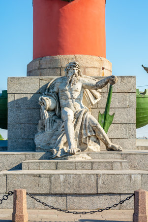 Statue under Rostral column in Saint Petersburg, Russiaのeditorial素材