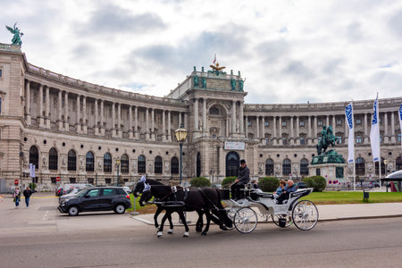 Vienna, Austria - October 2021: Horse carriage on Heldenplatz square and Hofburg palaceのeditorial素材