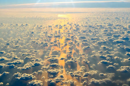 Airplane wing and view of clouds belowの写真素材