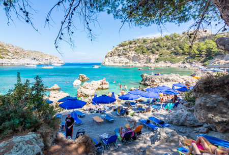 Rhodes, Greece - September 2018: Tourists on beach of Anthony Quinn Bayのeditorial素材