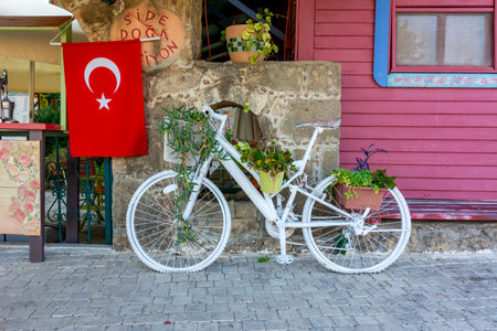 Side, Turkey - September 2021: Bicycle at cafe with flag of Turkeyのeditorial素材