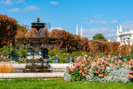 Vienna, Austria - October 2021: Fountain in Volksgarten park with Burg theater at backgroundのeditorial素材