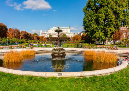 Vienna, Austria - October 2021: Fountain in Volksgarten park with Burg theater at backgroundのeditorial素材