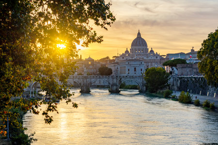 St. Peter's basilica dome and St. Angel bridge over Tiber river at sunset in Rome, Italyのeditorial素材