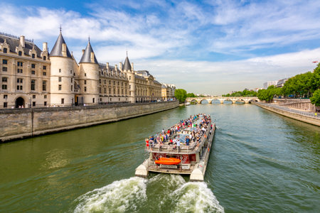 Paris, France - May 2019: Trip boat sailing along Seine river in Parisのeditorial素材