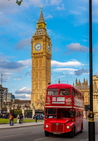 London, UK - 28 April 2024: Red double-decker bus on Parliament square and Big Ben tower
