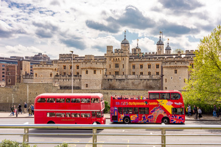 London, UK - 26 April 2024: Double-decker buses and Tower of London