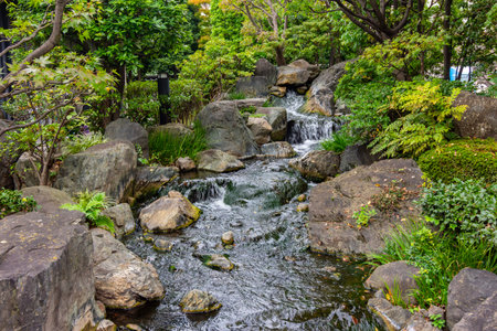 Tokyo, Japan - November 16, 2024: Waterfall in the garden of Senso-ji temple in Asakusa
