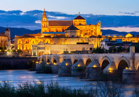Mezquita (Great Mosque of Cordoba) and Roman bridge at sunset, Spainの写真素材