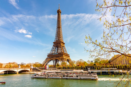 Eiffel Tower and cruise boat on Seine river in Paris, France