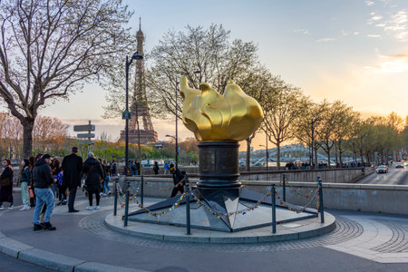 Paris, France - 02 April 2025: Flame of Liberty at Pont de l'Alma bridge and Eiffel towerの写真素材