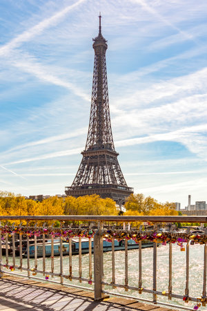 Paris, France - 06 April 2025: Eiffel tower and tourist locks on Debilly bridge over Seine riverの写真素材