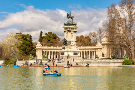 Madrid, Spain - 24 March 2025: Monument to Alfonso XII and Retiro pond in Buen Retiro park