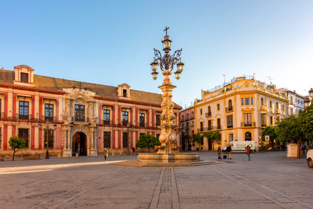 Seville, Spain - 28 March 2025: Farola fountain and Archbishop's palace on Virgen de los Reyes squareの写真素材