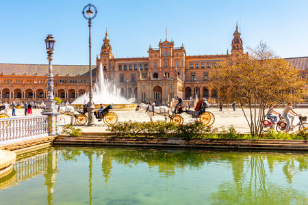 Seville, Spain - 28 March 2025: Horse carriages on Spain square in Maria Luisa parkの写真素材