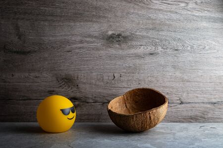 Coconut shell with smile lamp on tile backgroundの写真素材