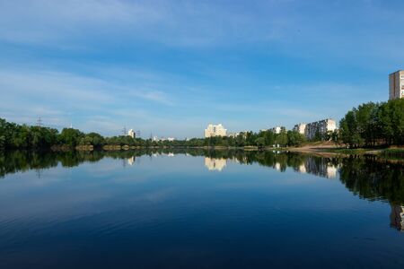 Landscape of a lake in the city with blue skyの写真素材
