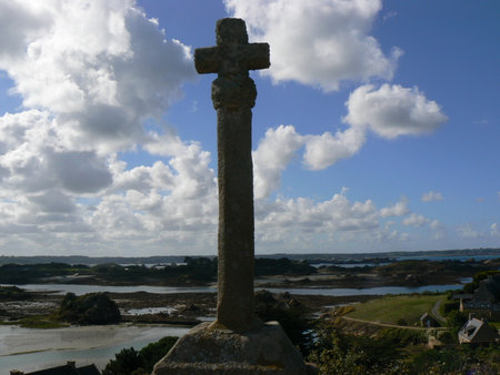 Cross on the coast of Brittany, France, with blue sky and white clouds (island of BrÃ©hat)の写真素材