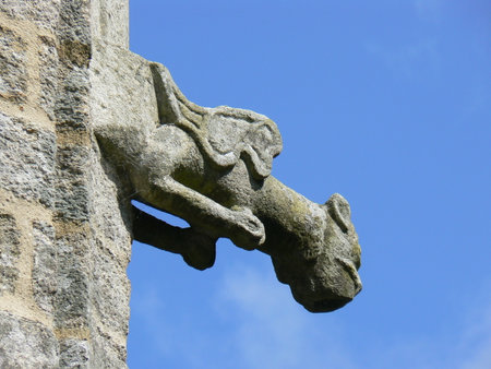 Sculpture of a gargoyle on the wall of chapel of Sainte Barbe, Brittany, Franceの写真素材