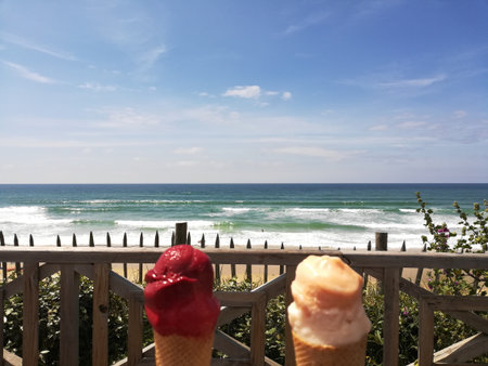 Ice cream cones on a wooden fence with the sea in the background, Lacanau, Franceの写真素材