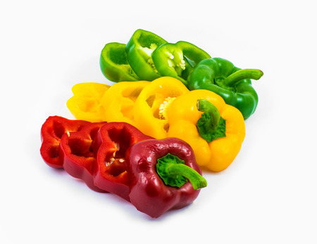 colorful sweet peppers sliced in pieces isolated on white backgroundの写真素材