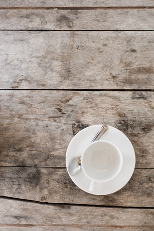 White cup on wood table の写真素材