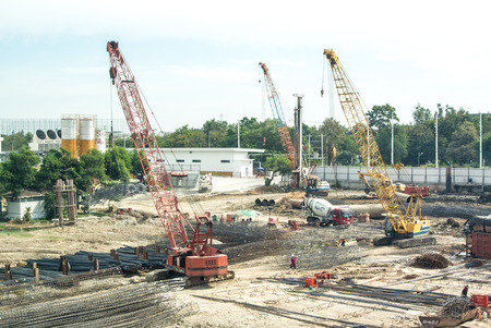 Crane operating among metal foundation polesのeditorial素材
