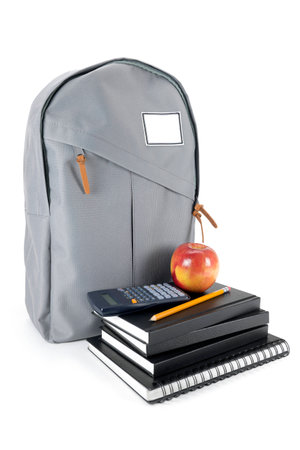 Backpack full of school supplies. on white background.