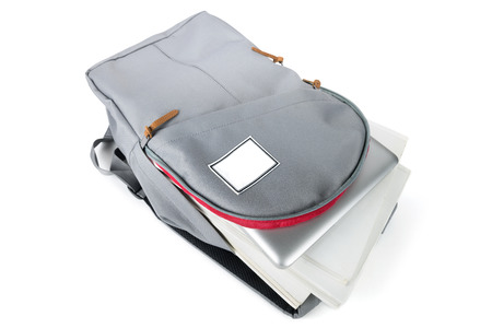 Backpack full of school supplies. on white background.