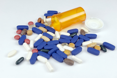 Prescription bottle on its side with pillsの写真素材