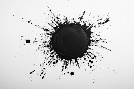 Bold black ink explosion with numerous splatters, forming a dramatic and expressive abstract pattern on a pristine white surface.の素材