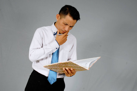 The supervisor is checking the reports from his undergraduateの写真素材