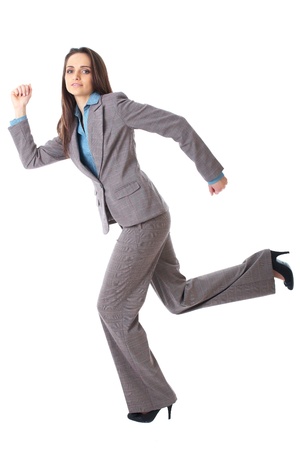 young happy businesswoman in a rush, run pose, isolated on whiteの写真素材