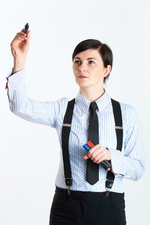 young female draws something in front of her, copy and creative space concept,  studio shoot on grey backgroundの写真素材