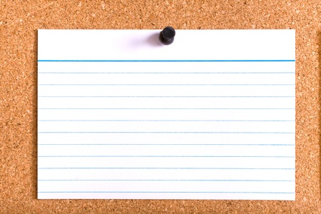 white stripped card with black pin on cork boardの写真素材