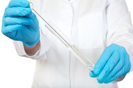 laboratory technician with blue gloves wash test tube using long brush, isolated