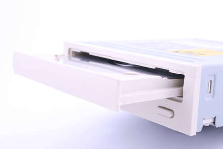 CD/DVD being being inserted into a computer.の写真素材