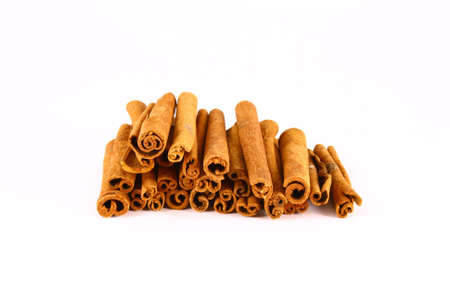 Sticks and powder of cinnamon reflected on the white background