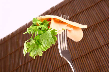 ham slices on fork with top slice foldedの写真素材