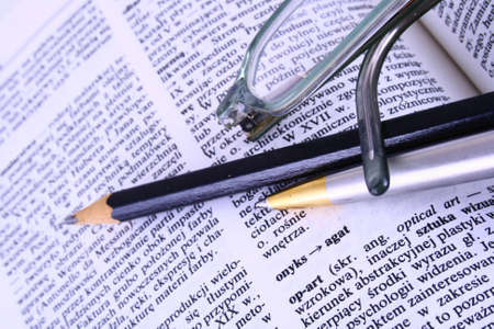 Glasses on opened book books color tonedの写真素材