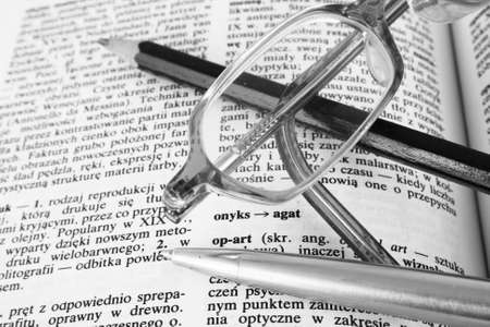 Glasses on opened book  black and white tonedの写真素材