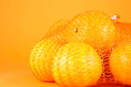 orange Clementines in a netted bag and boxの写真素材