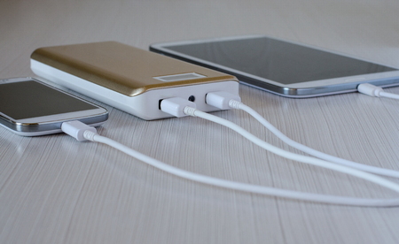 Powerbank charges the smartphone and tablet computerの写真素材