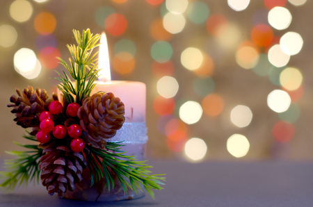 Decorative candle with berries and cones. Background - bokehの写真素材