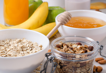 Healthy Breakfast - Oatmeal with raisins. Honey, bananas, green apples, nutsの写真素材