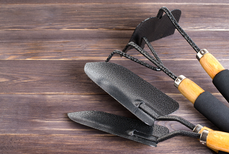 Garden tools for soil. Wooden background. Close up. Space for textの写真素材