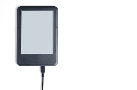 E-book reader with cable on white background. Flat top view. Space for textの写真素材