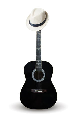Black guitar with wearing a white hat. On white background isolated. Vertical photoの写真素材